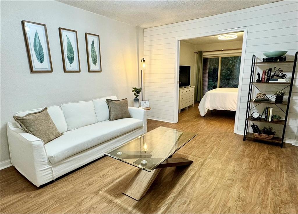 250 Little Street, Unit D107 Athens, GA 30605 - Photo 2 of 20 a living room with furniture and a couch