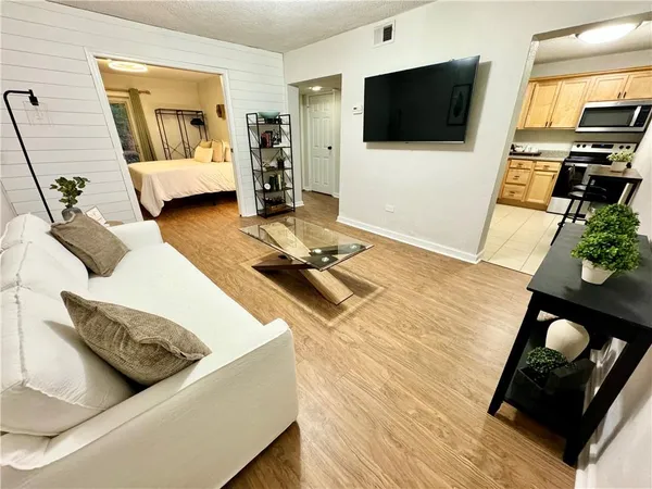 a living room with furniture and a flat screen tv