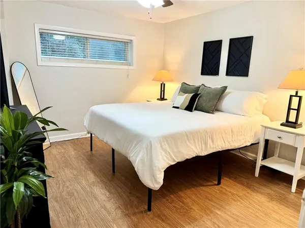a bedroom with a bed and a potted plant
