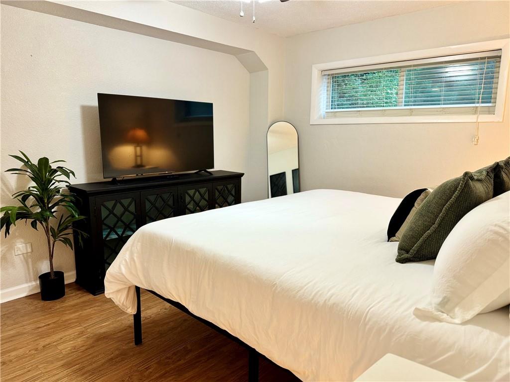 250 Little Street, Unit D107 Athens, GA 30605 - Photo 6 of 20 a bedroom with a bed and a flat screen tv
