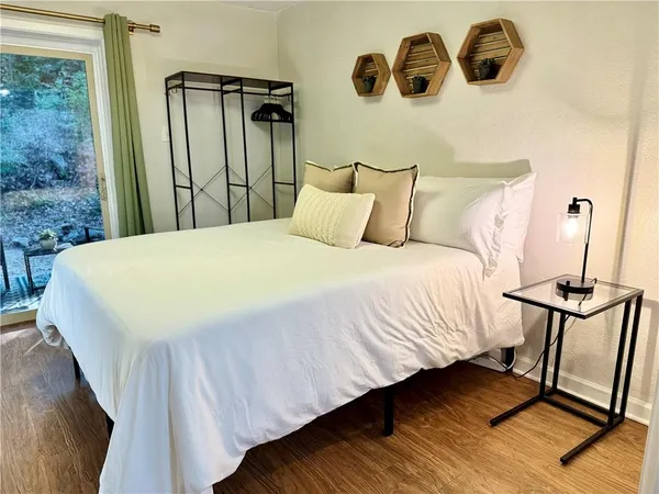 a bedroom with a bed and wooden floor