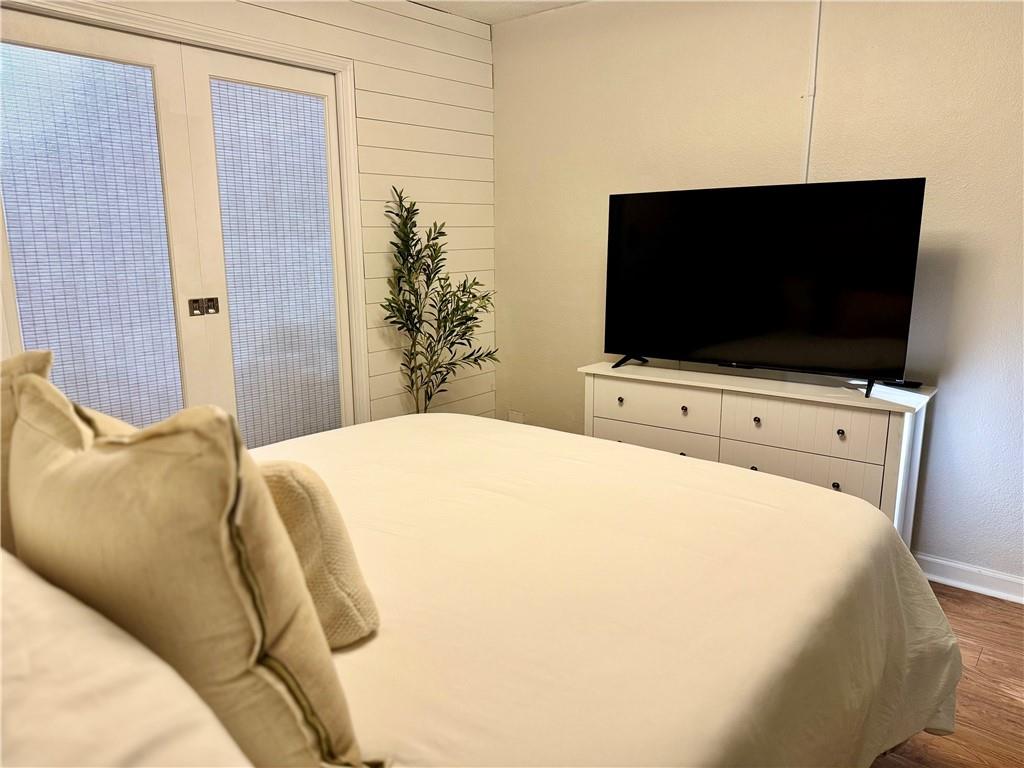 250 Little Street, Unit D107 Athens, GA 30605 - Photo 10 of 20 a bedroom with a bed and a flat screen tv