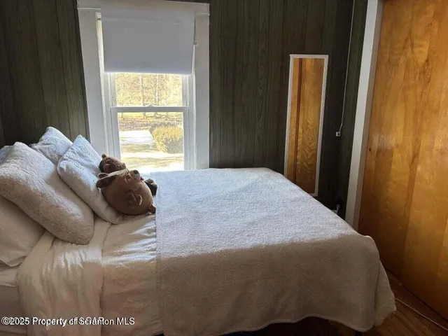 a bed sitting in a bedroom next to a window