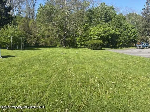 a view of outdoor space with deck and yard