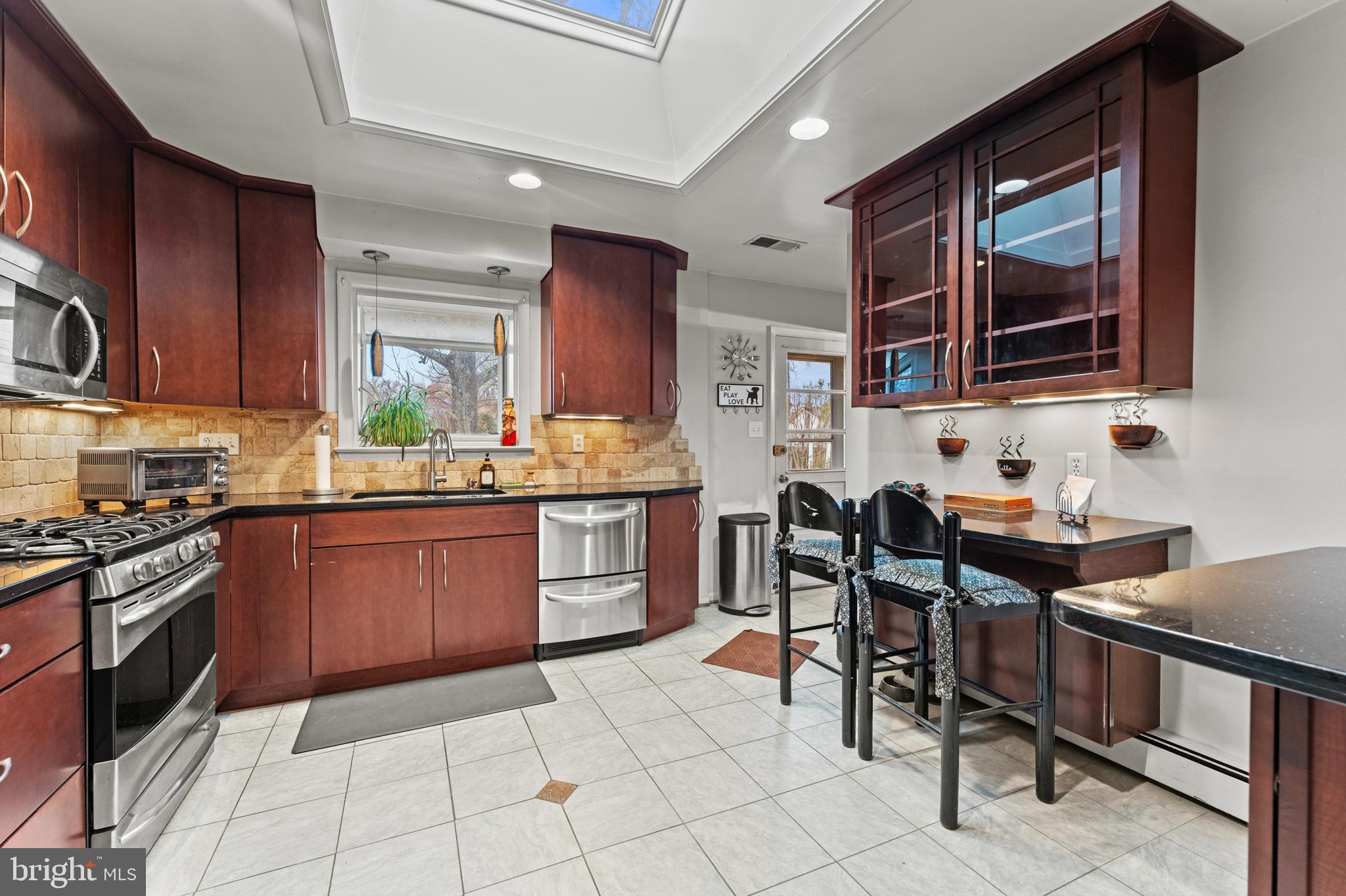 6805 Pamela Lane Clinton, MD 20735 - Photo 12 of 39 a kitchen with granite countertop a sink stove and cabinets