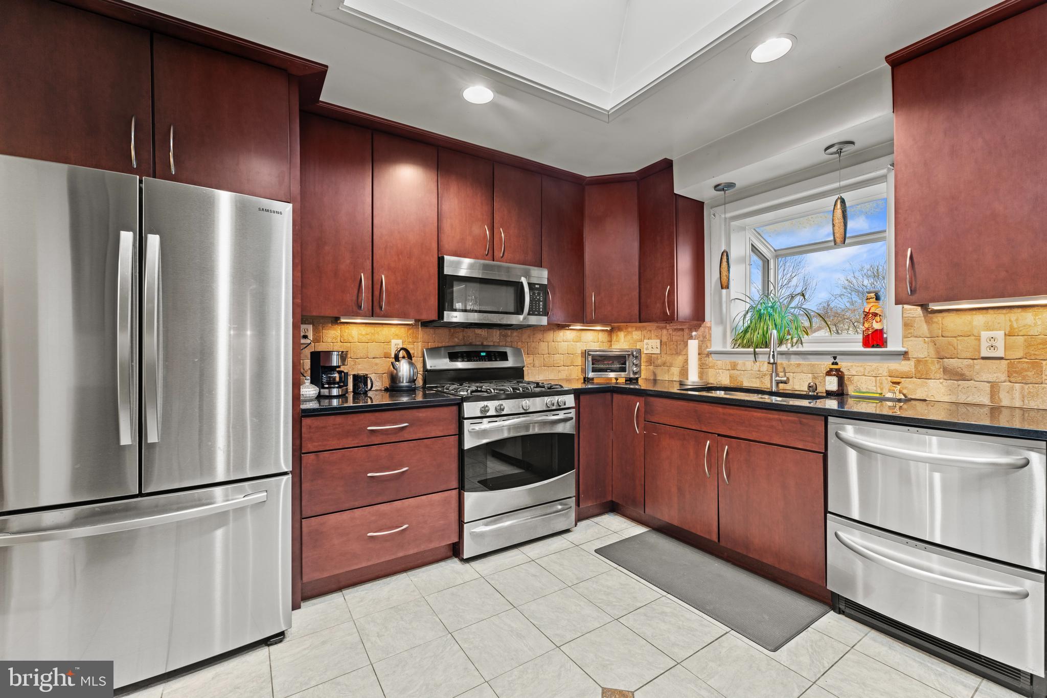 6805 Pamela Lane Clinton, MD 20735 - Photo 13 of 39 a kitchen with stainless steel appliances granite countertop a refrigerator stove a sink dishwasher and microwave