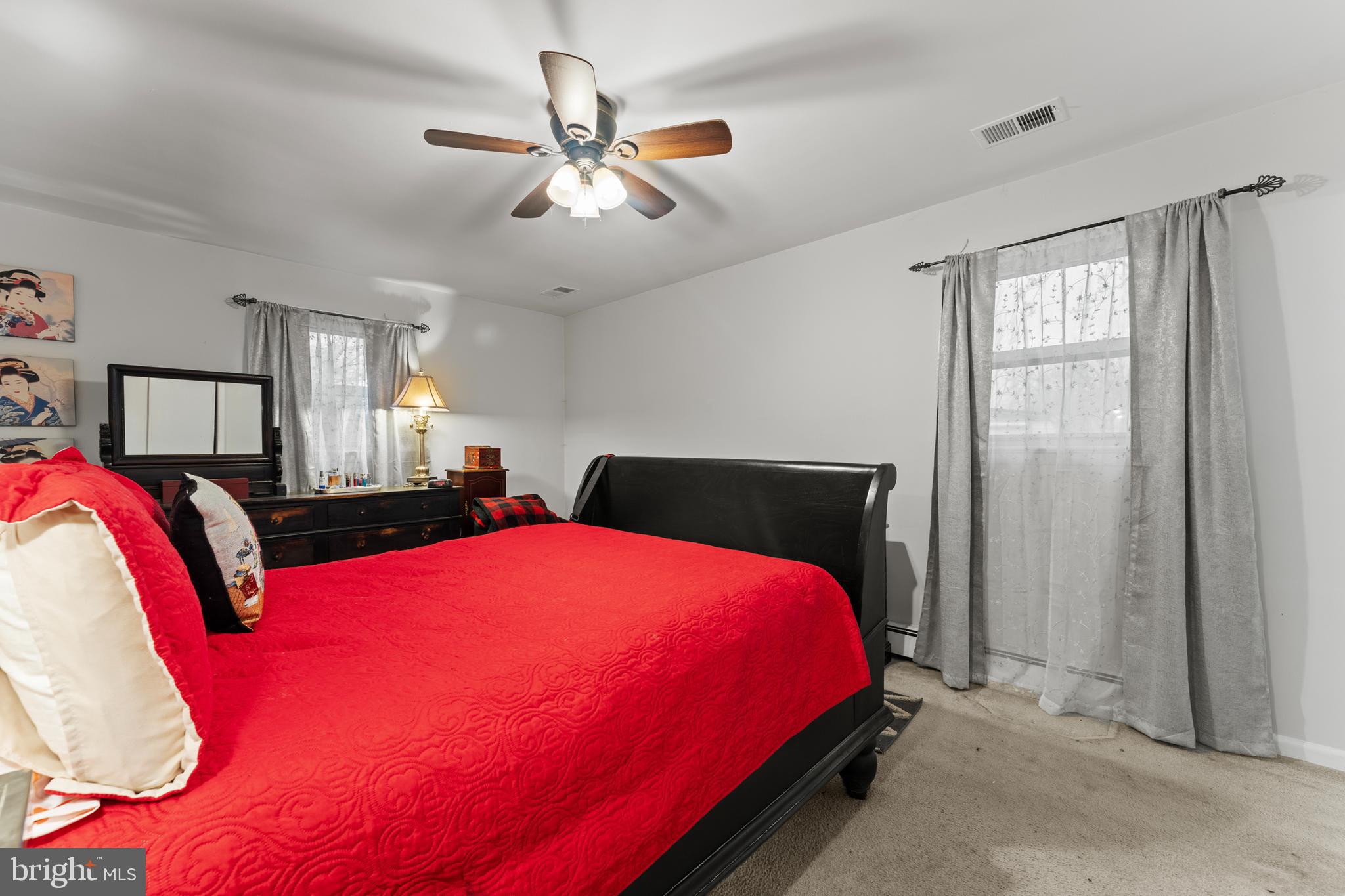 6805 Pamela Lane Clinton, MD 20735 - Photo 15 of 39 a bedroom with a bed and a chandelier