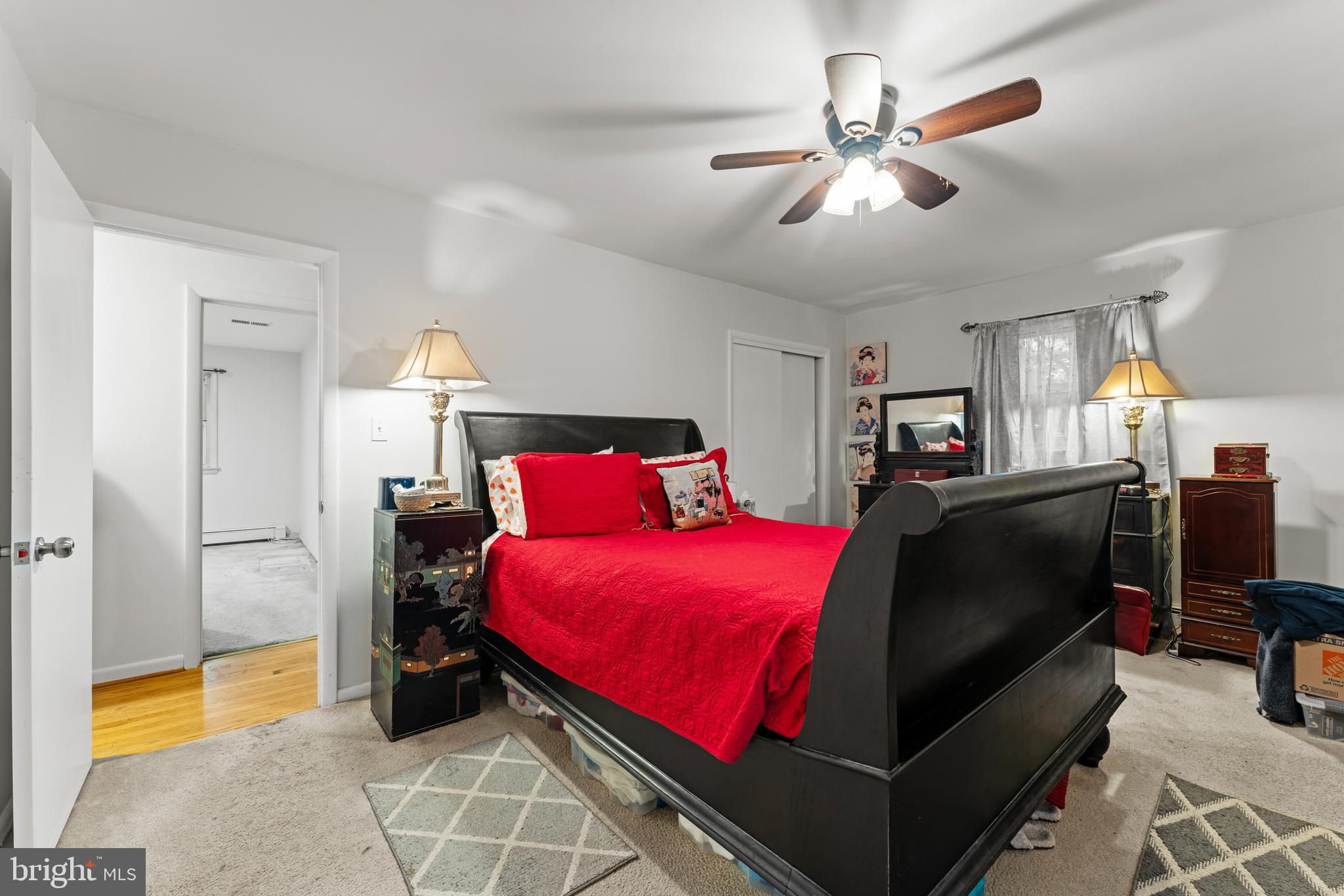 6805 Pamela Lane Clinton, MD 20735 - Photo 16 of 39 a bedroom with a bed and a chandelier