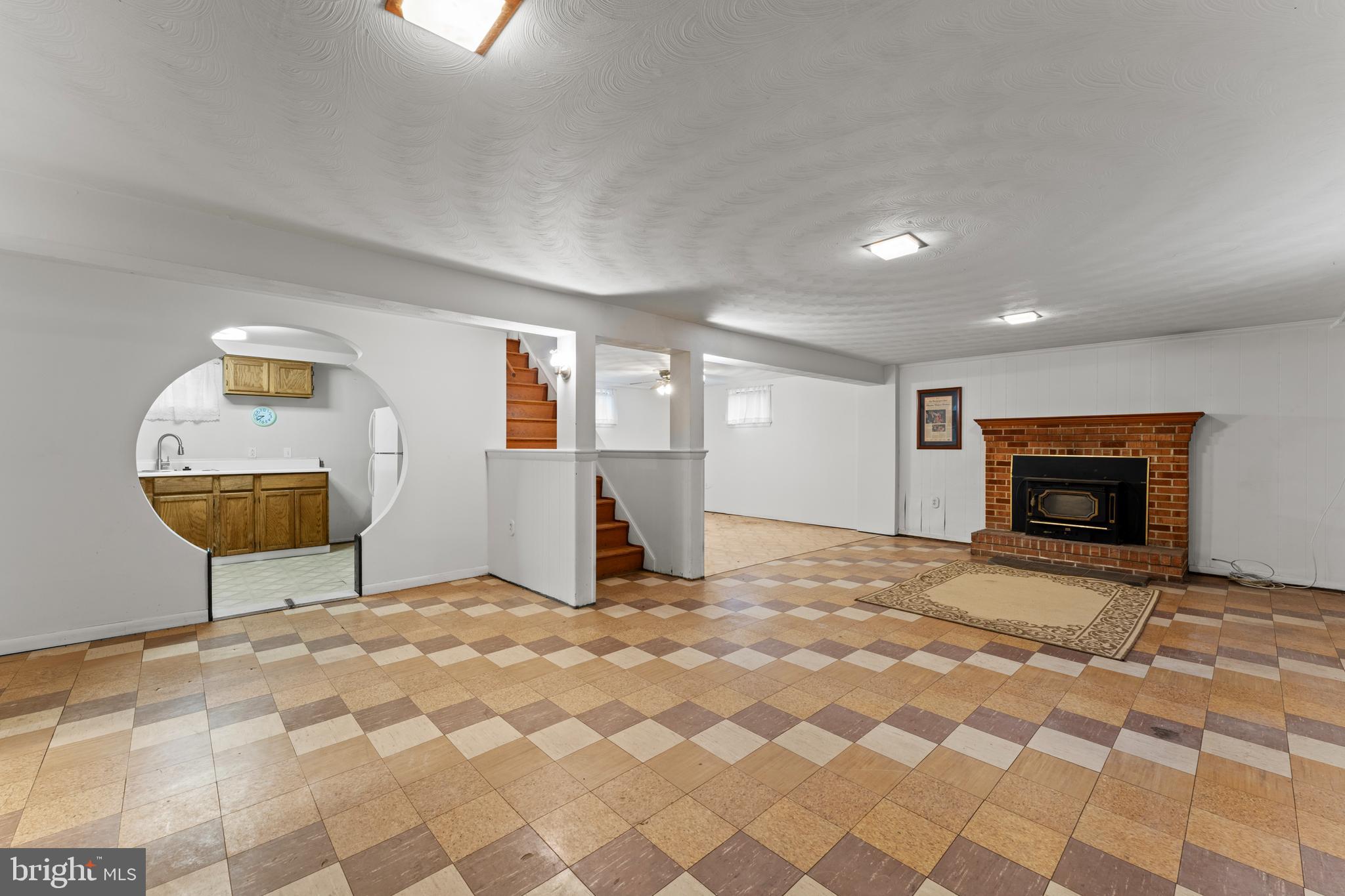 6805 Pamela Lane Clinton, MD 20735 - Photo 24 of 39 a view of a livingroom with wooden floor and a fireplace