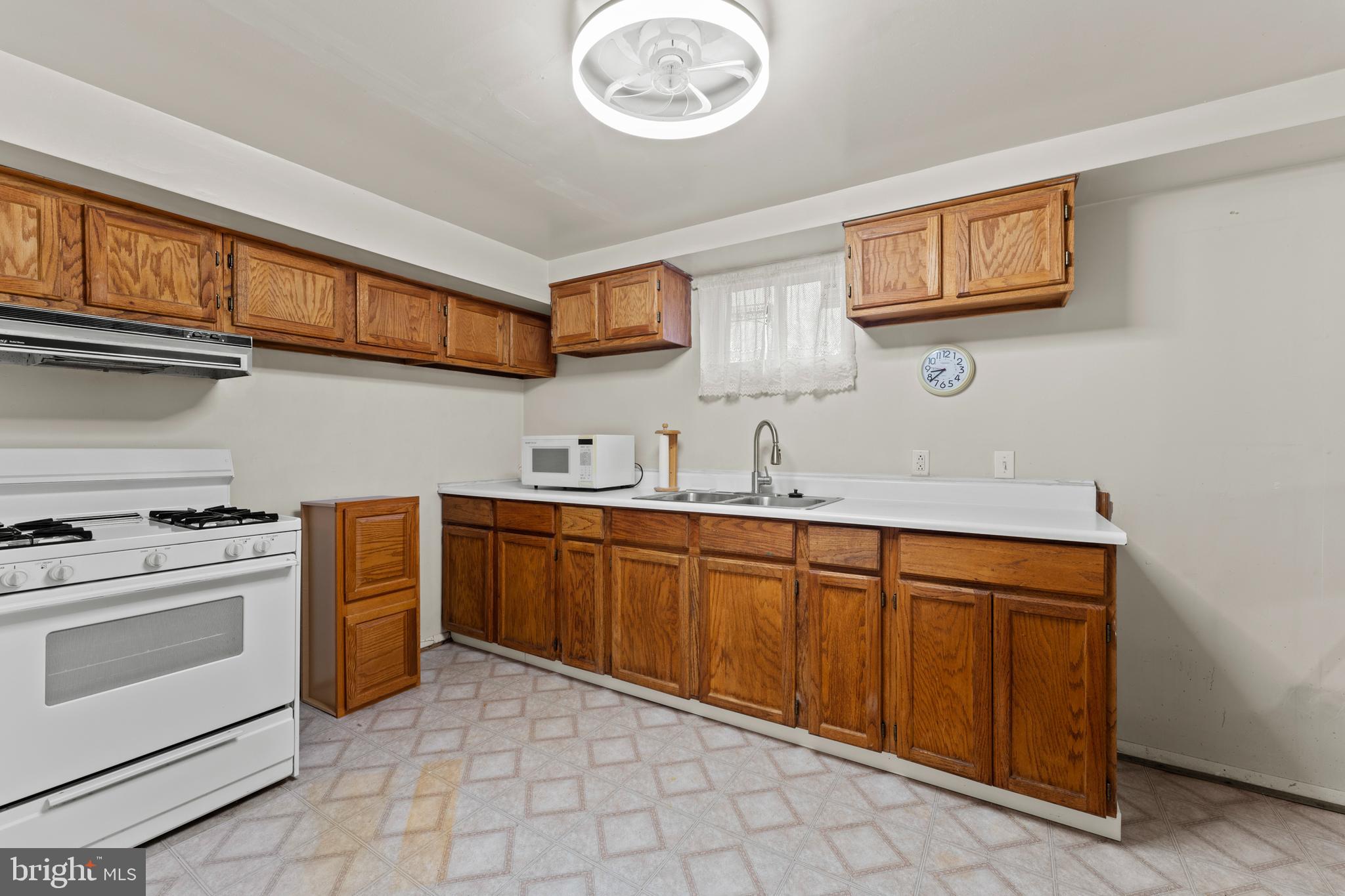 6805 Pamela Lane Clinton, MD 20735 - Photo 26 of 39 a kitchen with stainless steel appliances granite countertop a stove and a sink