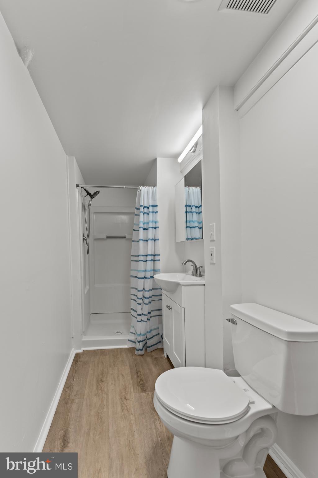 6805 Pamela Lane Clinton, MD 20735 - Photo 32 of 39 a bathroom with a toilet and a shower