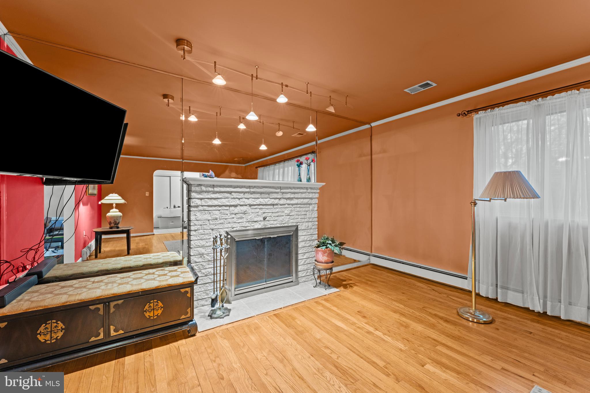 6805 Pamela Lane Clinton, MD 20735 - Photo 4 of 39 a living room with furniture flat screen tv and a fireplace