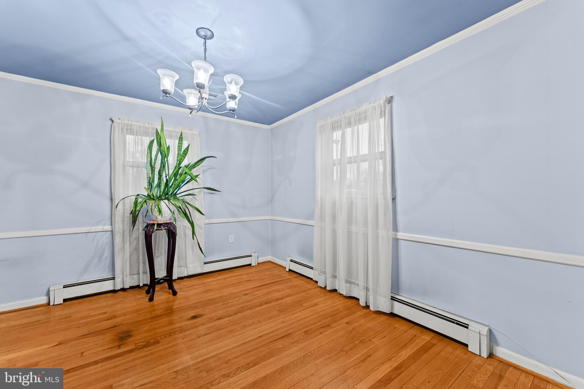 6805 Pamela Lane Clinton, MD 20735 - Photo 5 of 39 a view of a room with a chandelier and wooden floor