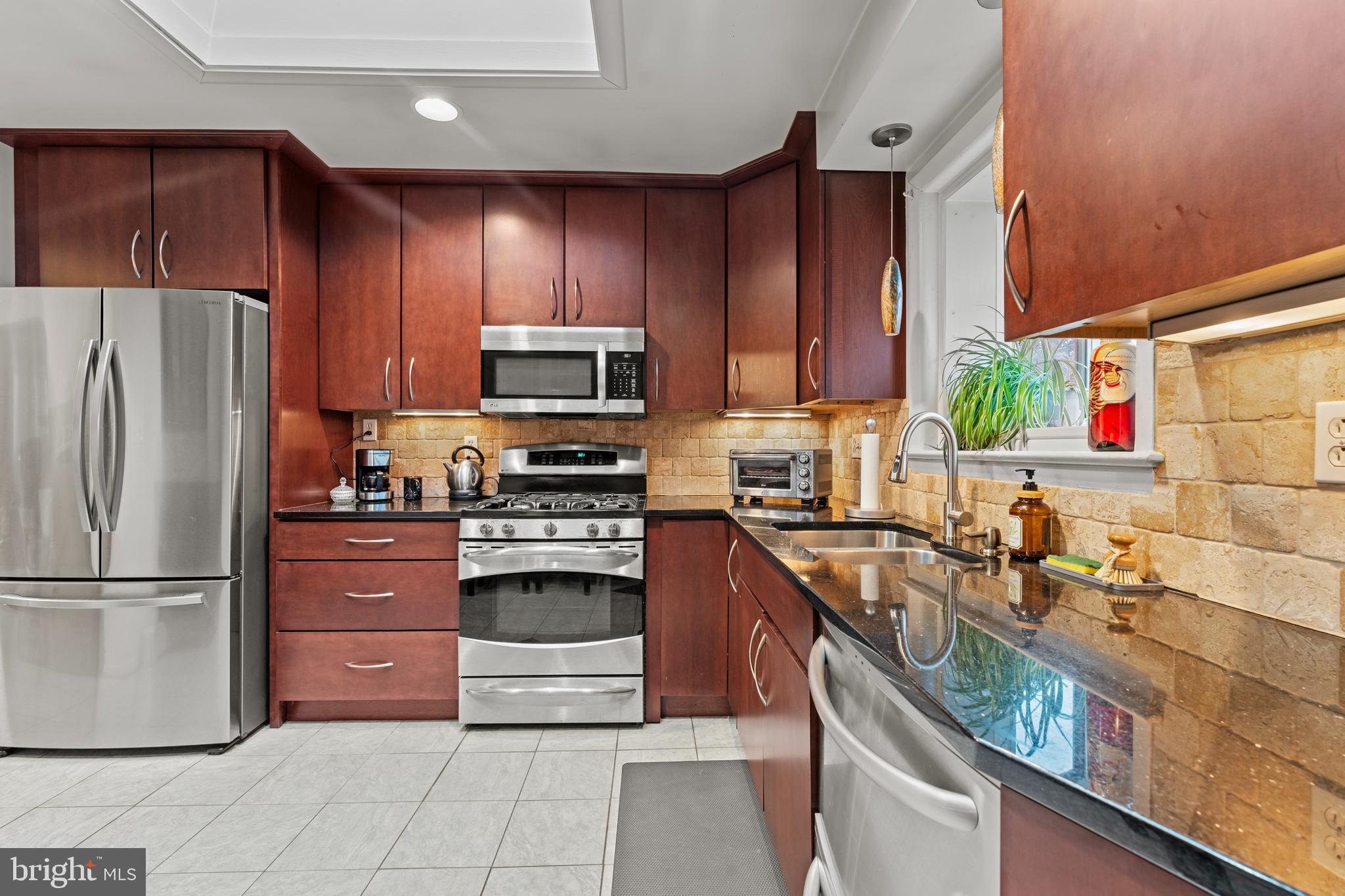 6805 Pamela Lane Clinton, MD 20735 - Photo 10 of 39 a kitchen with stainless steel appliances granite countertop a refrigerator stove and sink