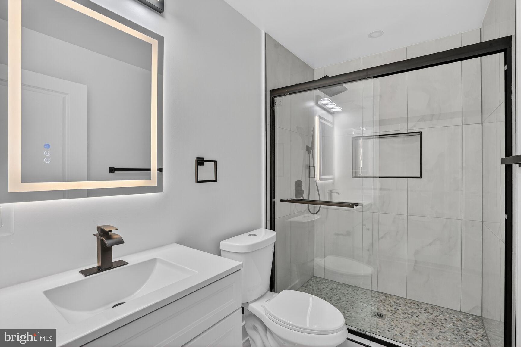 4629 9th Street Northwest Washington, DC 20011 - Photo 22 of 41 a bathroom with a sink a toilet and shower