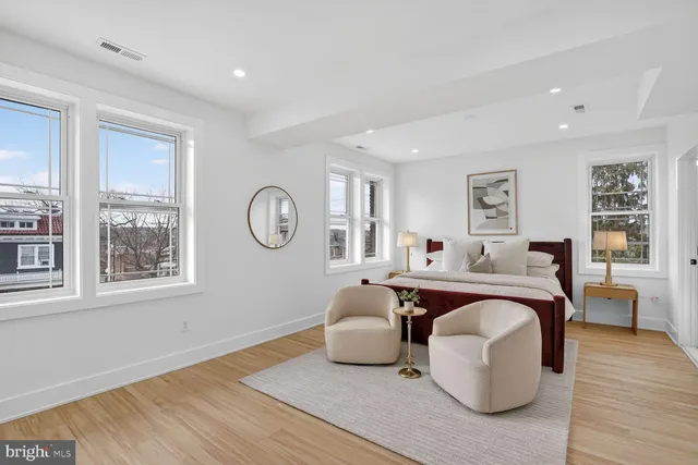 a living room with furniture a wooden floor and a window