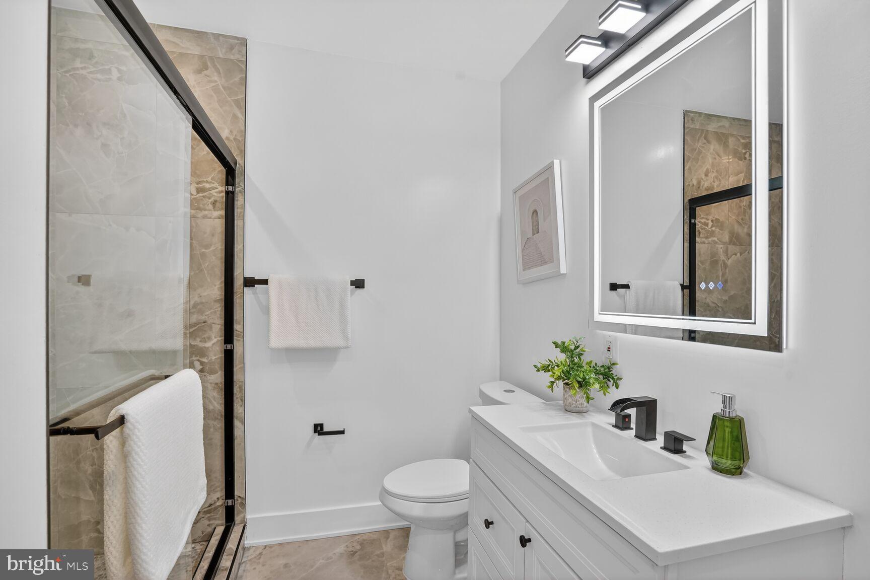 4629 9th Street Northwest Washington, DC 20011 - Photo 27 of 41 a bathroom with a sink toilet and shower