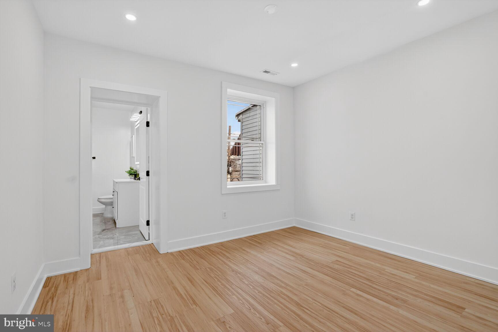 4629 9th Street Northwest Washington, DC 20011 - Photo 29 of 41 an empty room with wooden floor and a window