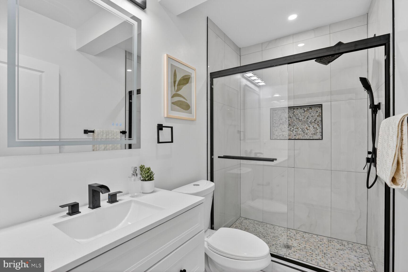 4629 9th Street Northwest Washington, DC 20011 - Photo 32 of 41 a bathroom with a sink toilet and shower