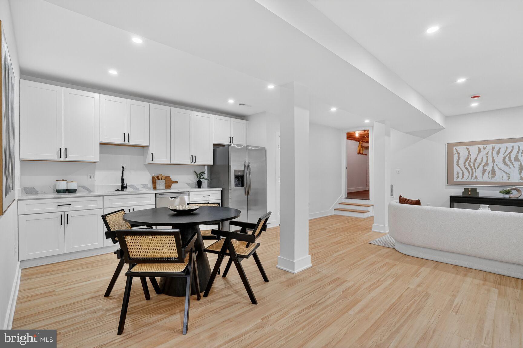 4629 9th Street Northwest Washington, DC 20011 - Photo 34 of 41 a kitchen with stainless steel appliances kitchen island granite countertop a table chairs sink and cabinets