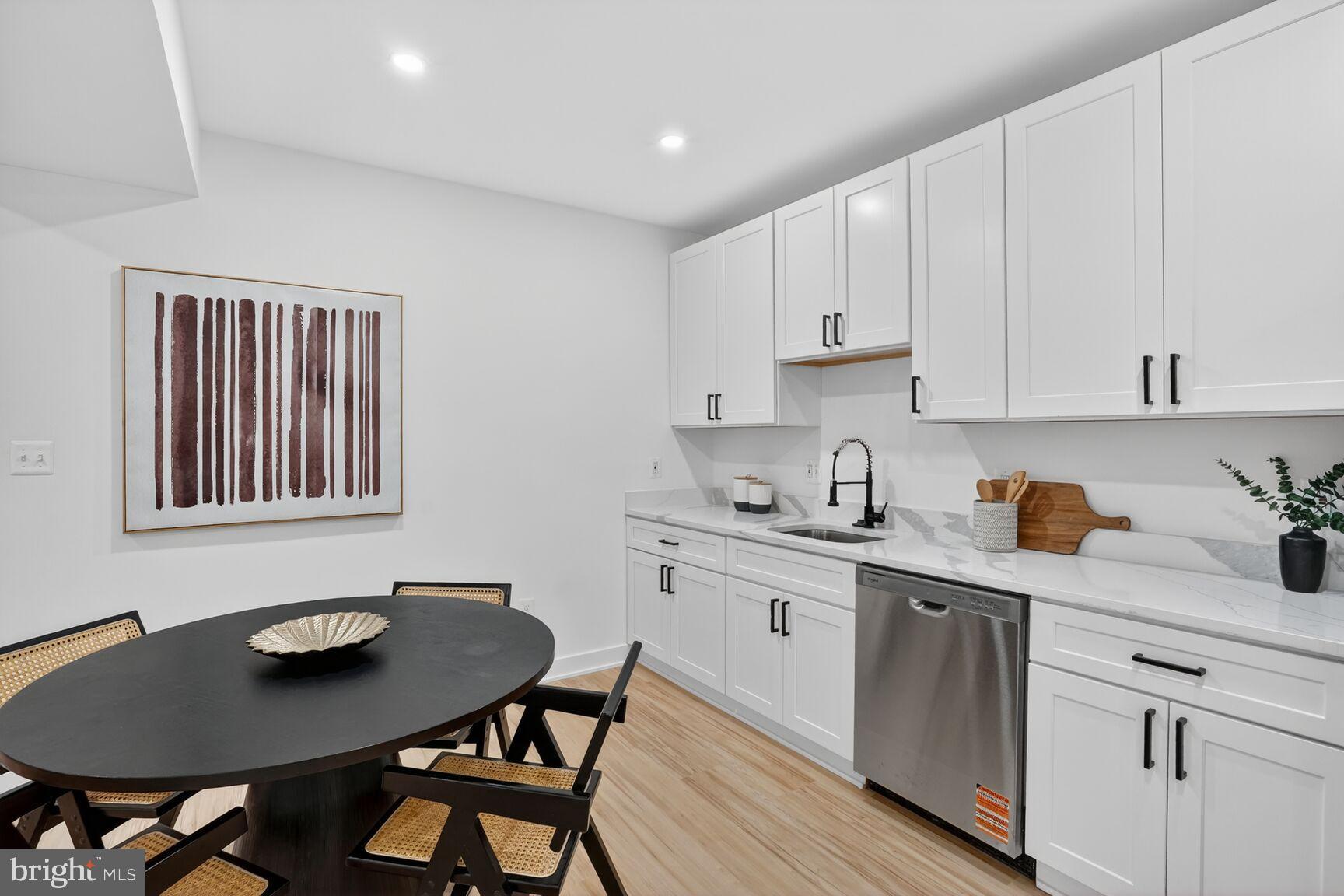 4629 9th Street Northwest Washington, DC 20011 - Photo 35 of 41 a kitchen with stainless steel appliances granite countertop a table chairs sink and cabinets