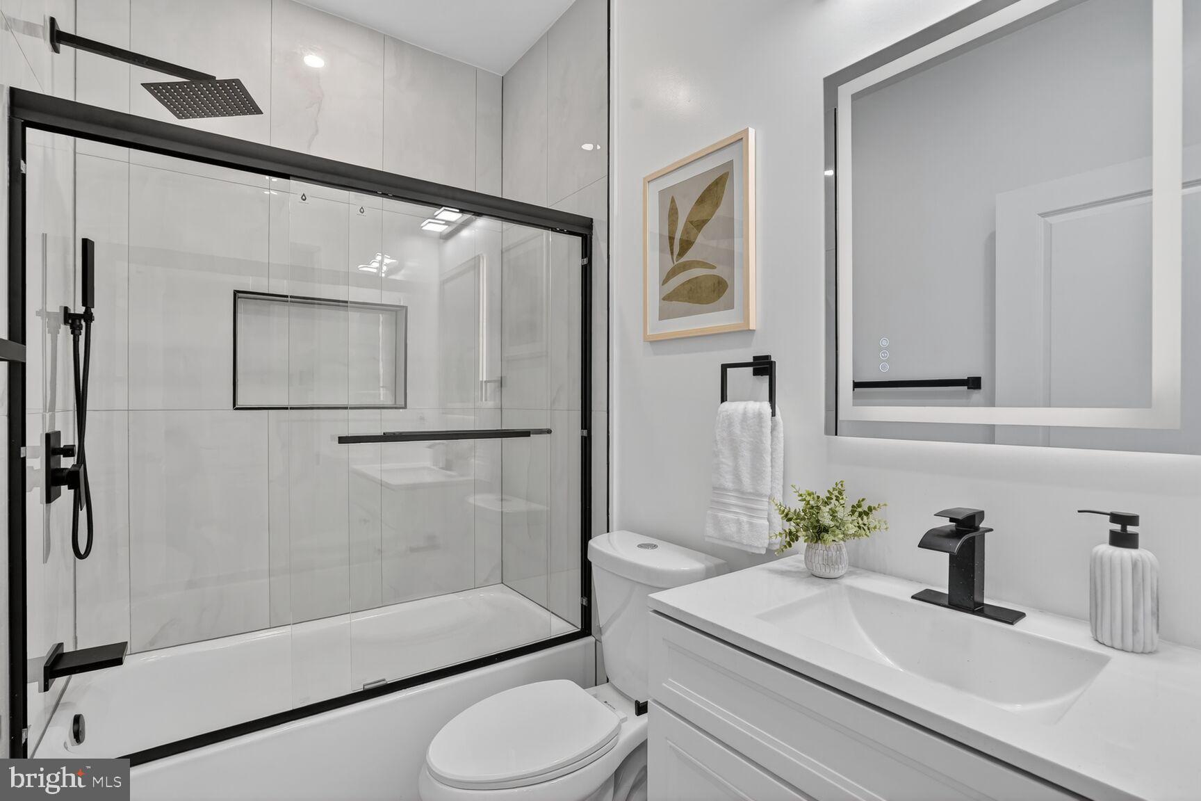 4629 9th Street Northwest Washington, DC 20011 - Photo 38 of 41 a bathroom with a sink a toilet and shower