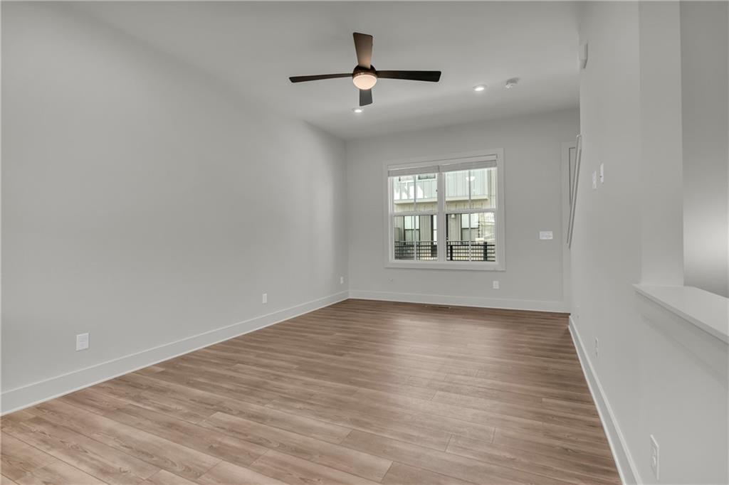 152 Chestnut Circle Atlanta, GA 30342 - Photo 16 of 53 wooden floor in an empty room with a window