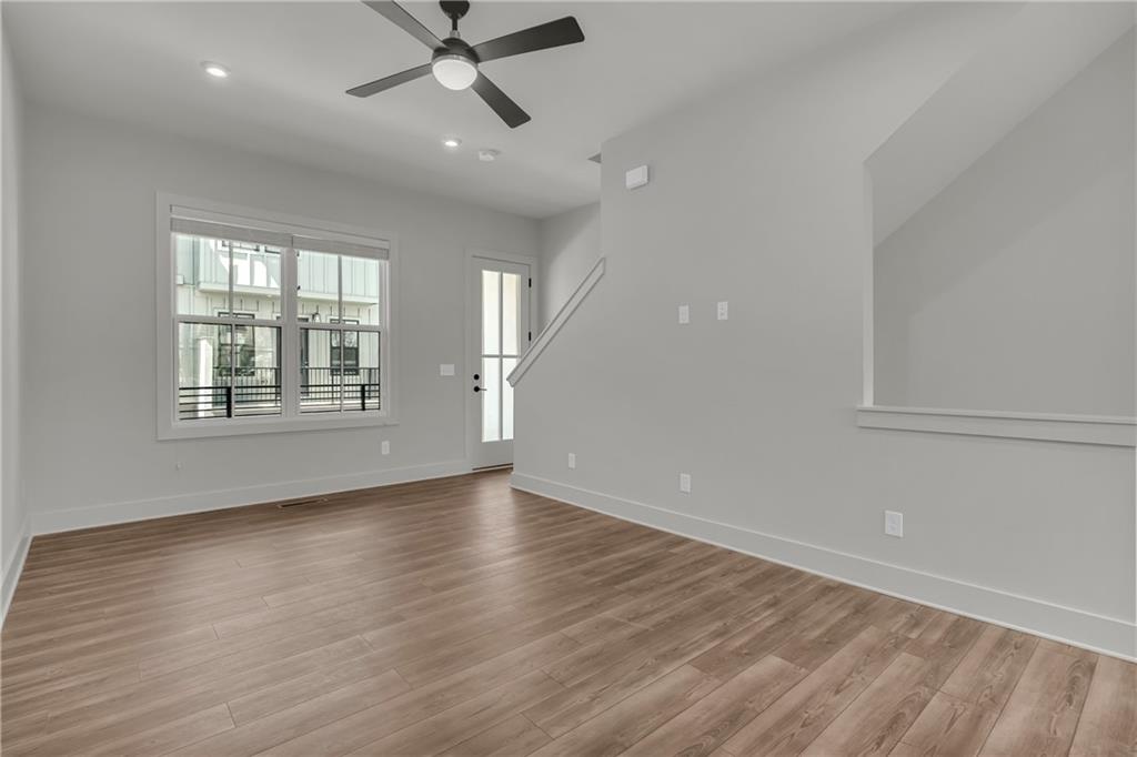 152 Chestnut Circle Atlanta, GA 30342 - Photo 17 of 53 an empty room with wooden floor fan and windows