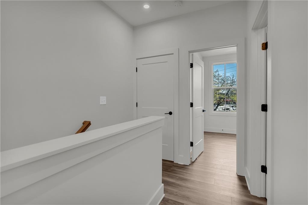 152 Chestnut Circle Atlanta, GA 30342 - Photo 22 of 53 a hallway with wooden floor and closet