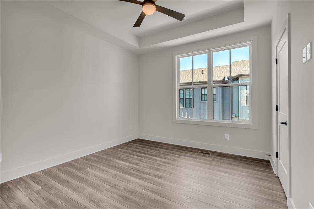 152 Chestnut Circle Atlanta, GA 30342 - Photo 29 of 53 a view of an empty room with a window and wooden floor