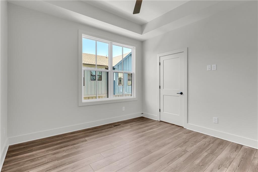 152 Chestnut Circle Atlanta, GA 30342 - Photo 32 of 53 an empty room with wooden floor and windows