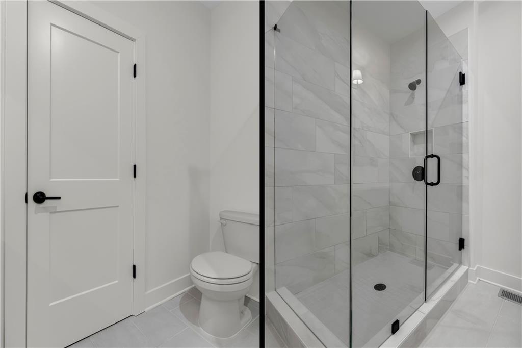 152 Chestnut Circle Atlanta, GA 30342 - Photo 38 of 53 a bathroom with a shower and a toilet