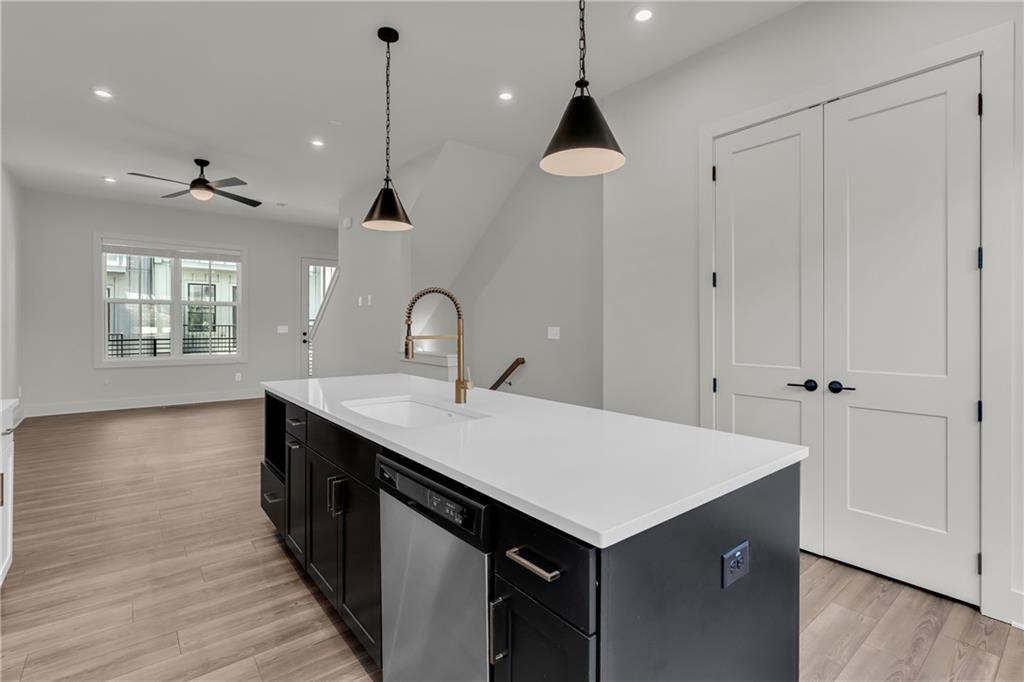 152 Chestnut Circle Atlanta, GA 30342 - Photo 9 of 53 a kitchen with a sink chandelier and wooden floor