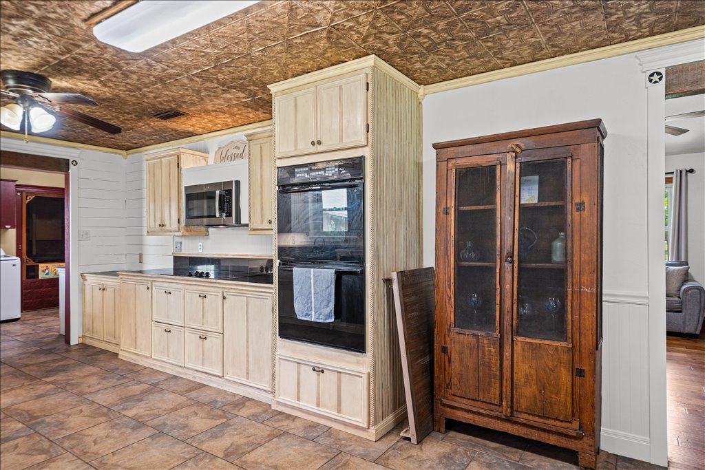 2421 Post Oak Road Webberville, TX 78653 - Photo 9 of 36 You’ve got built-in double ovens, a cooktop, and plenty of cabinet space with a light, distressed finish that fits the home's style perfectly.