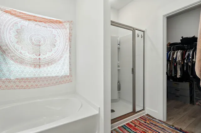 a bathroom with a bathtub and a shower