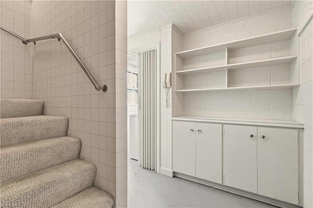 1040 Cantering Road High Point, NC 27262 - Photo 24 of 49 Stairs and lower level storage area to laundry room