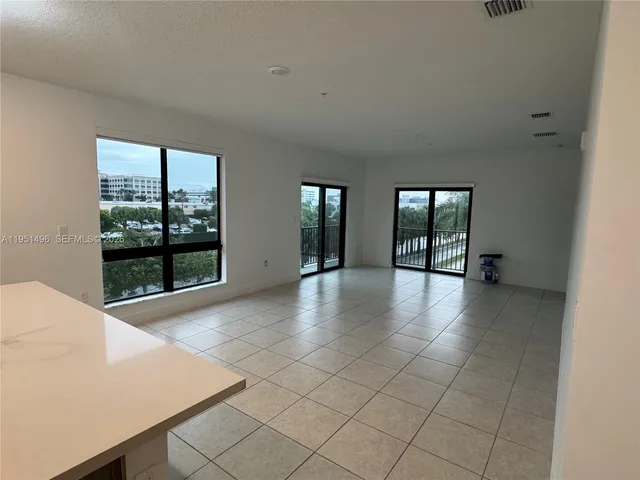 a view of an empty room with glass door