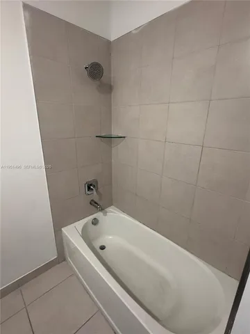 a bathroom with a bathtub and shower