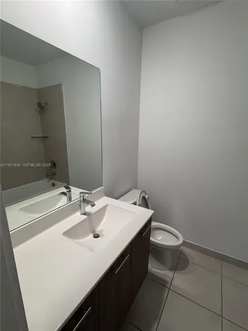 a bathroom with a sink a toilet and mirror