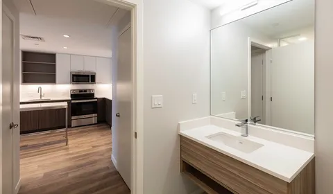 a kitchen with kitchen island a sink stainless steel appliances and cabinets