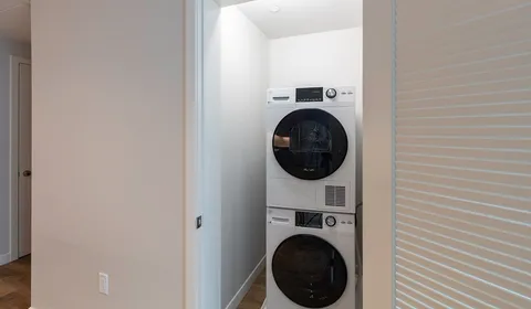 a view of a hallway with washer and dryer