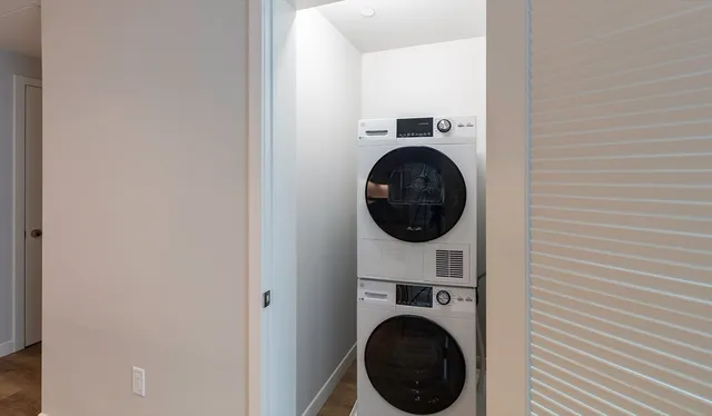 a view of a hallway with washer and dryer