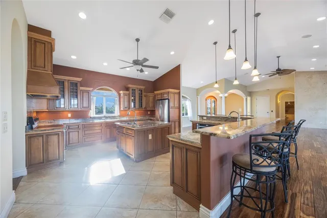 a kitchen with stainless steel appliances granite countertop a sink counter space and a stove