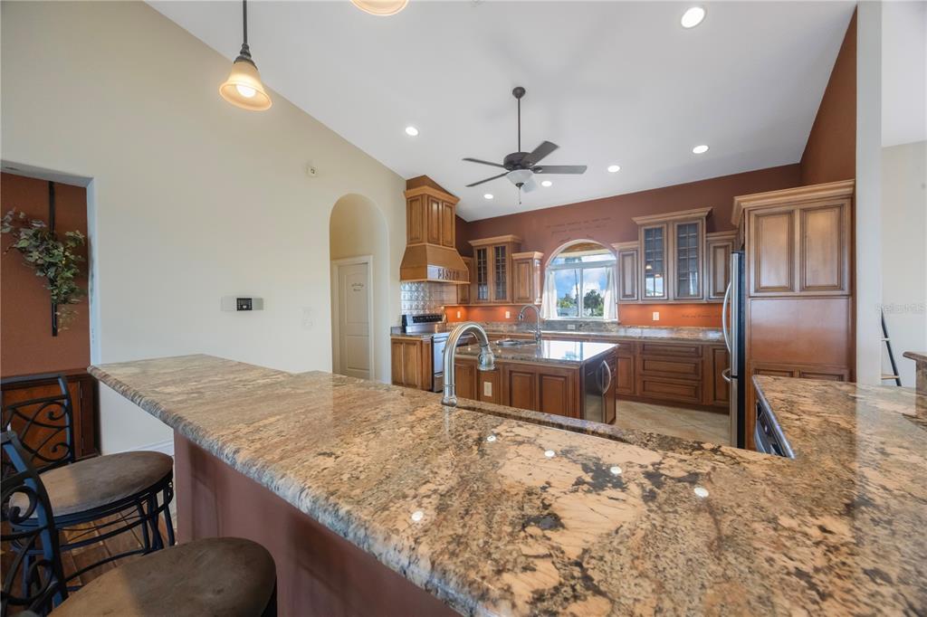 736 Pruitt Drive Madeira Beach, FL 33708 - Photo 12 of 42 a view of kitchen with granite countertop cabinets and refrigerator