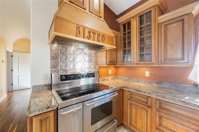 a kitchen with stainless steel appliances granite countertop a stove and a sink