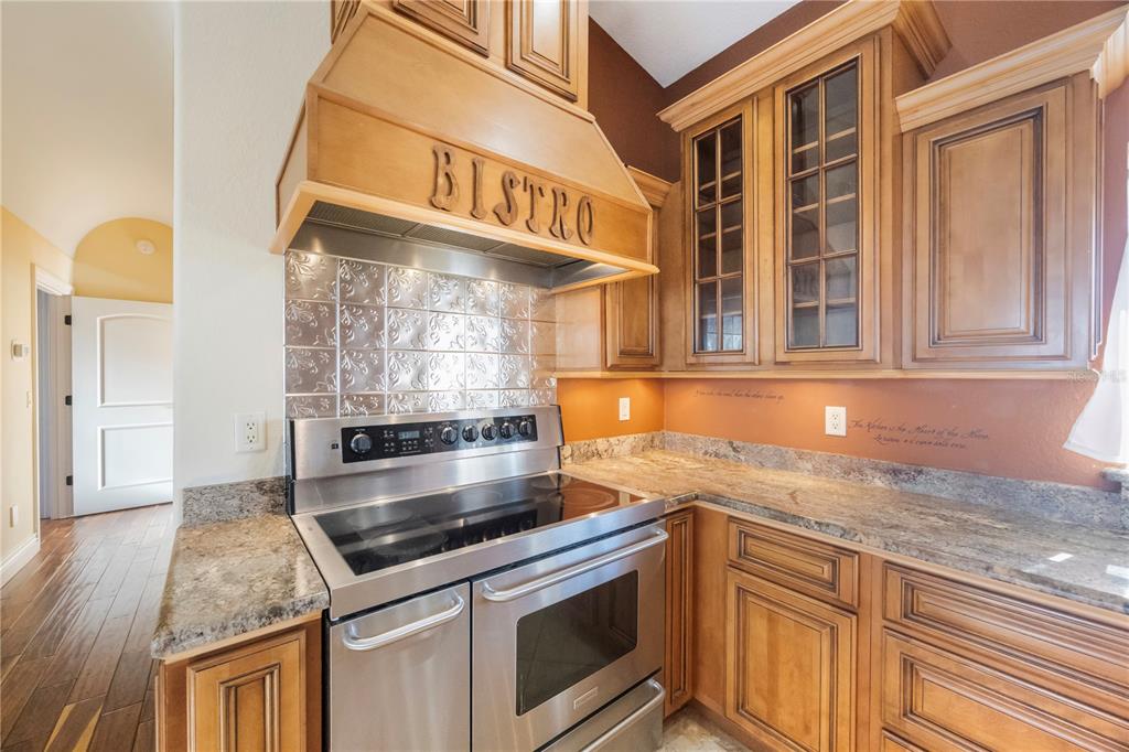 736 Pruitt Drive Madeira Beach, FL 33708 - Photo 16 of 42 a kitchen with stainless steel appliances granite countertop a stove and a sink