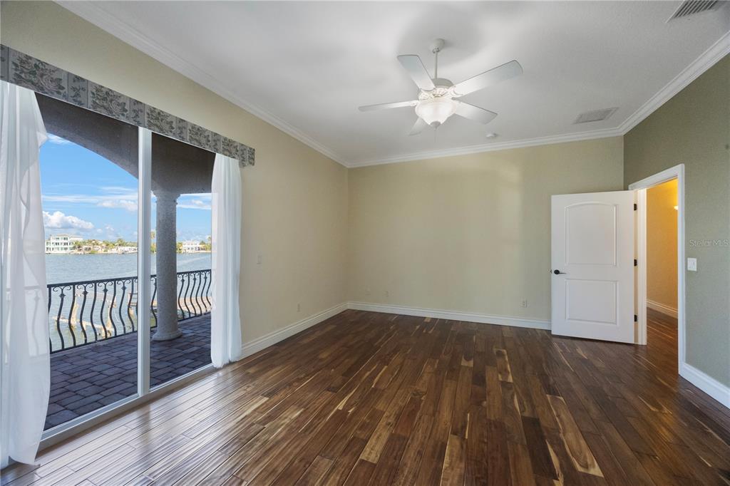 736 Pruitt Drive Madeira Beach, FL 33708 - Photo 21 of 42 wooden floor in an empty room with a window