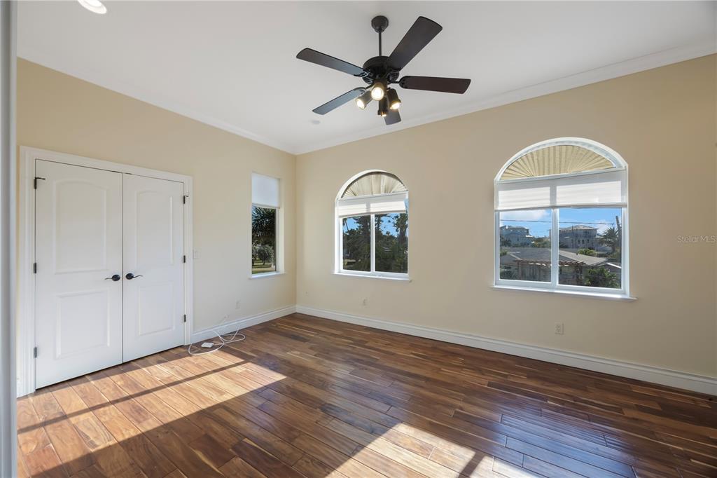 736 Pruitt Drive Madeira Beach, FL 33708 - Photo 25 of 42 a view of an livingroom with wooden floor and a ceiling fan
