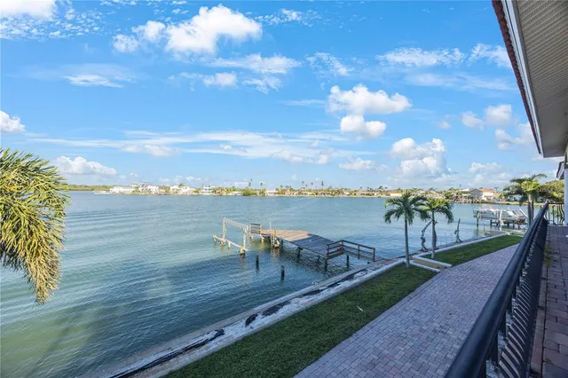 a view of a terrace with lawn chairs