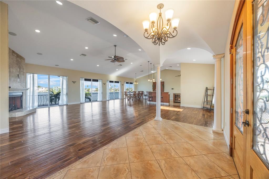 736 Pruitt Drive Madeira Beach, FL 33708 - Photo 4 of 42 a view of a hallway with wooden floor and chandelier